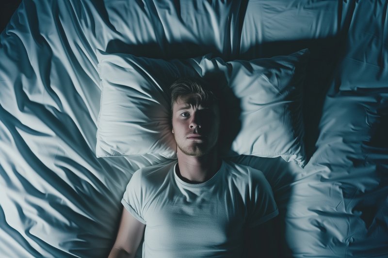 a man waking up troubled in bed